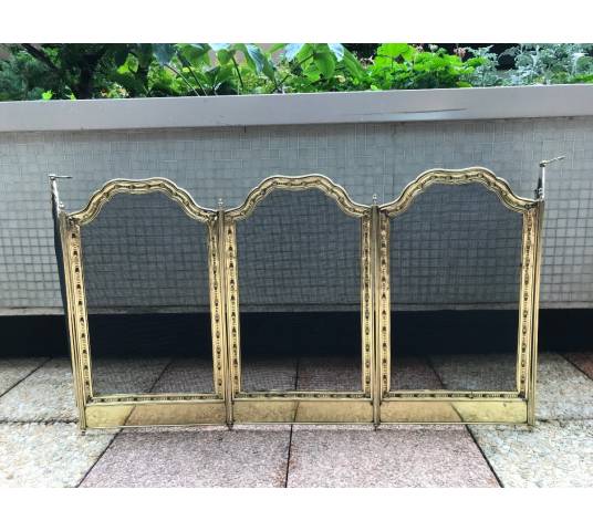 Large firewalls of old fireplace in polished brass and period varnish 19 th