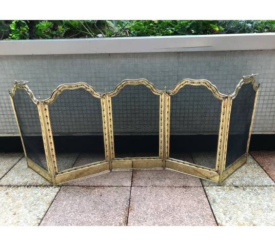 Large firewalls of old fireplace in polished brass and period varnish 19 th