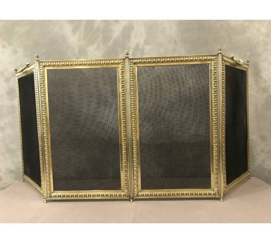 Old fireplace firewall in pressed brass from the 19th century