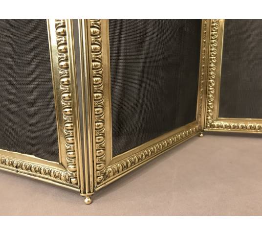 Old fireplace firewall in pressed brass from the 19th century