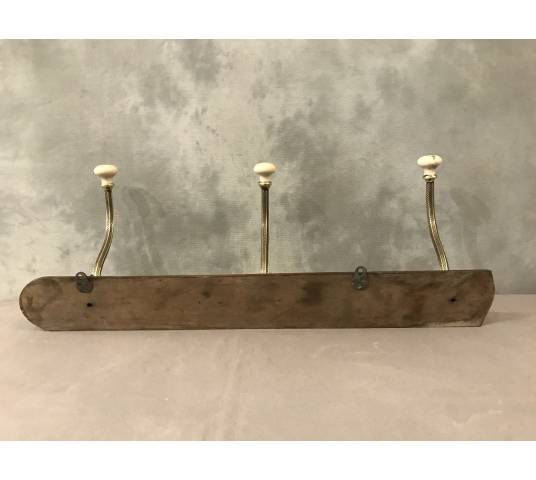 Brass and ceramic coat rack bar from the late 19th century