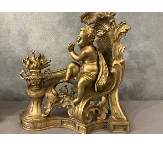 Pair of andirons, decorated with a fire motif in gilt bronze, dating from the 19th century