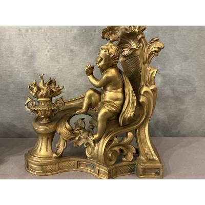 Pair of andirons, decorated with a fire motif in gilt bronze, dating from the 19th century