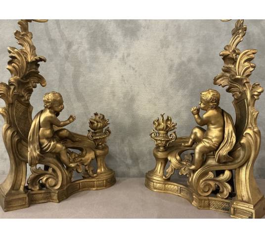 Pair of andirons, decorated with a fire motif in gilt bronze, dating from the 19th century