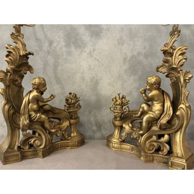 Pair of andirons, decorated with a fire motif in gilt bronze, dating from the 19th century