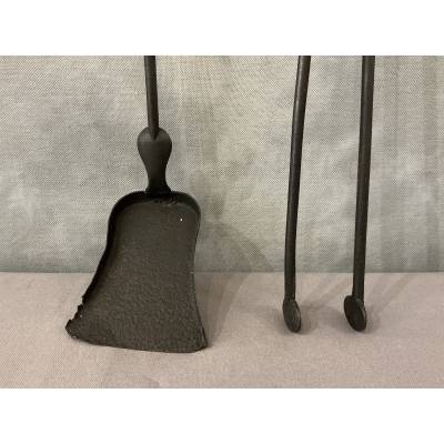 A 19th-century iron and bronze fireplace set consisting of a shovel and tongs.