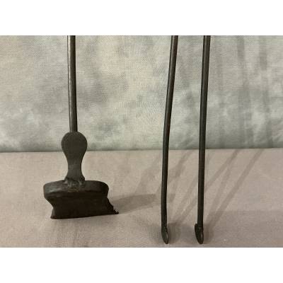 A 19th-century iron and bronze fireplace set consisting of a shovel and tongs.