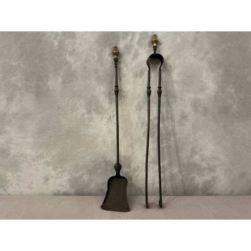 A 19th-century iron and bronze fireplace set consisting of a shovel and tongs.
