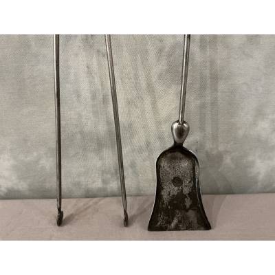 A 19th-century iron and brass fireplace shovel and tongs set