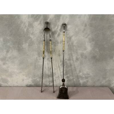 A 19th-century iron and brass fireplace shovel and tongs set