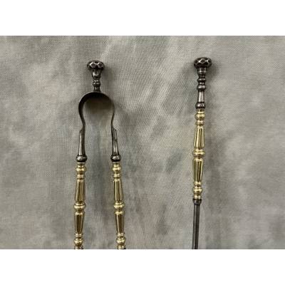 A 19th-century iron and brass fireplace shovel and tongs set