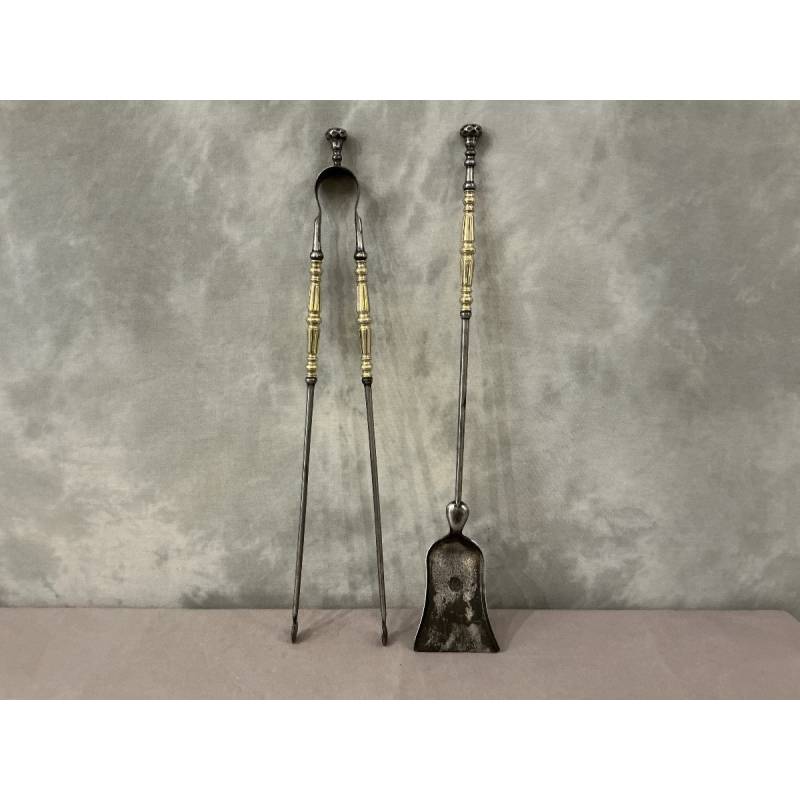 A 19th-century iron and brass fireplace shovel and tongs set