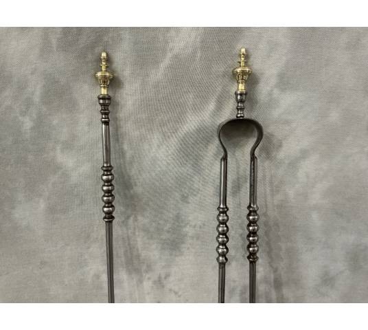 A 19th-century iron and brass fireplace shovel and tongs set
