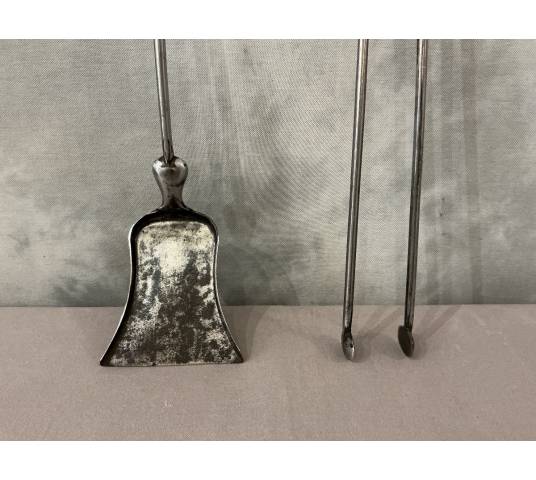 A 19th-century iron and brass fireplace shovel and tongs set