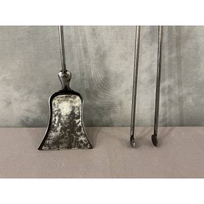 A 19th-century iron and brass fireplace shovel and tongs set