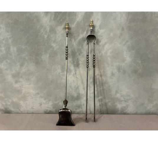 A 19th-century iron and brass fireplace shovel and tongs set