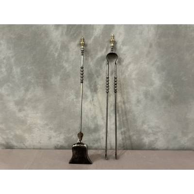 A 19th-century iron and brass fireplace shovel and tongs set