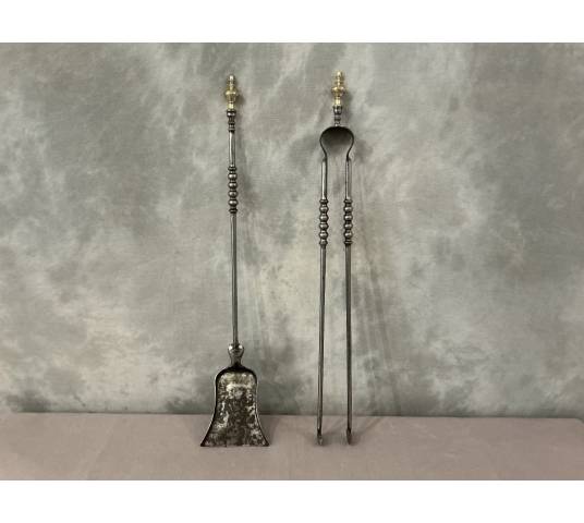 A 19th-century iron and brass fireplace shovel and tongs set