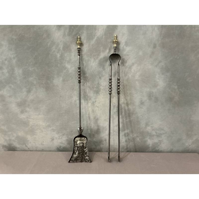 A 19th-century iron and brass fireplace shovel and tongs set