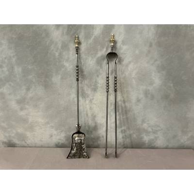 A 19th-century iron and brass fireplace shovel and tongs set