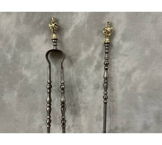 A 19th-century iron and bronze shovel and tongs set
