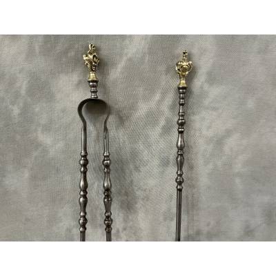 A 19th-century iron and bronze shovel and tongs set