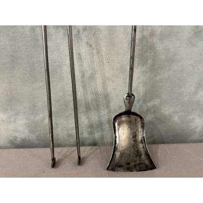 A 19th-century iron and bronze shovel and tongs set