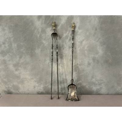 A 19th-century iron and bronze shovel and tongs set