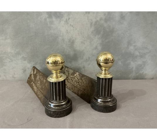 Pair of antique cast iron and brass andirons from the 19th century