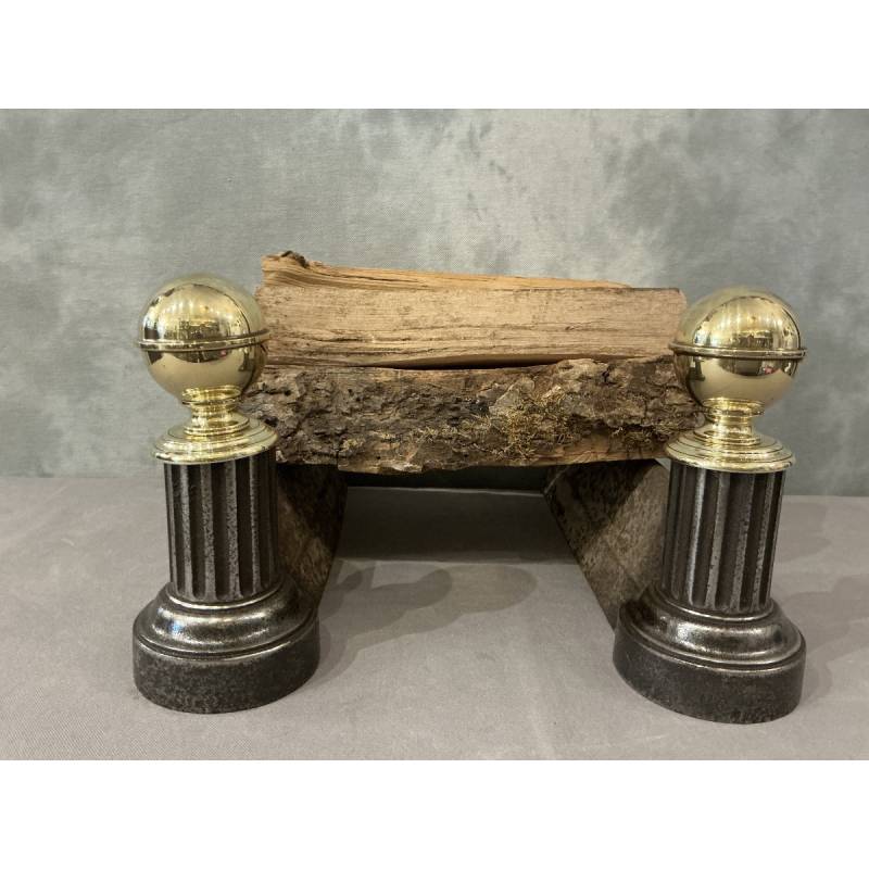 Pair of antique cast iron and brass andirons from the 19th century