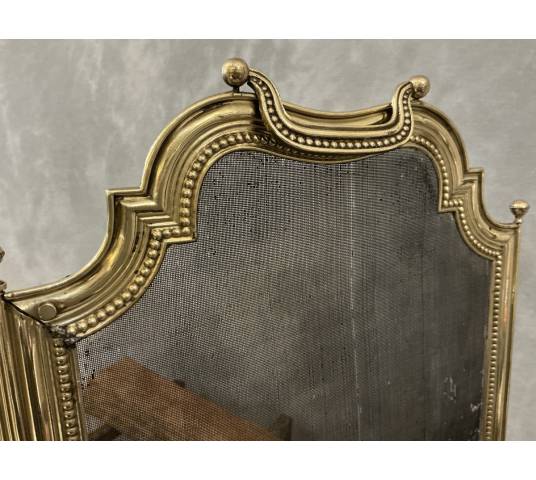 Small antique brass fire screen dating from the 19th century in the Louis XVI style