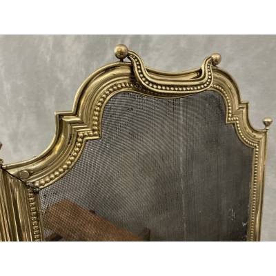 Small antique brass fire screen dating from the 19th century in the Louis XVI style