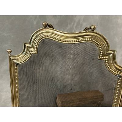 Small antique brass fire screen dating from the 19th century in the Louis XVI style