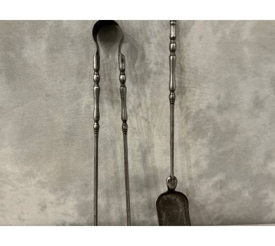 A set of a 19th-century iron fireplace shovel and tongs.