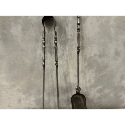 A set of a 19th-century iron fireplace shovel and tongs.