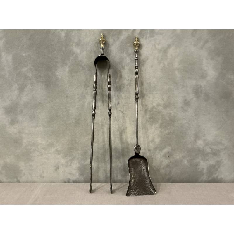 A set of a 19th-century iron fireplace shovel and tongs.
