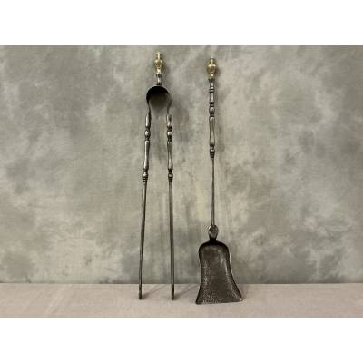 A set of a 19th-century iron fireplace shovel and tongs.