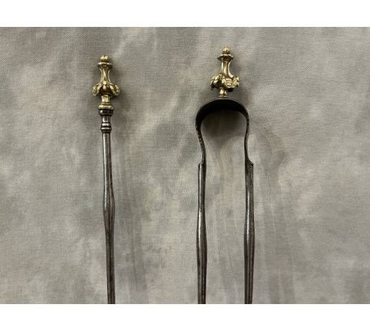 A 19th-century iron and bronze shovel and tongs set