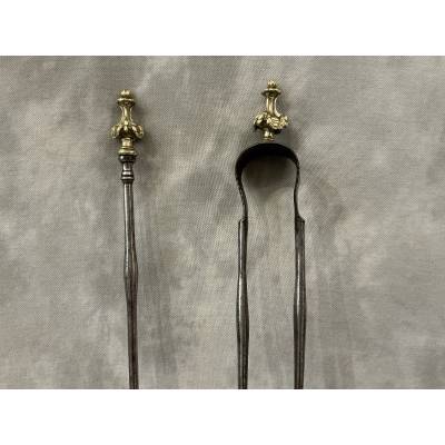 A 19th-century iron and bronze shovel and tongs set