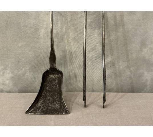 A 19th-century iron and bronze shovel and tongs set