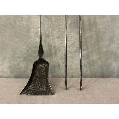 A 19th-century iron and bronze shovel and tongs set