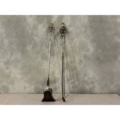 A 19th-century iron and bronze shovel and tongs set