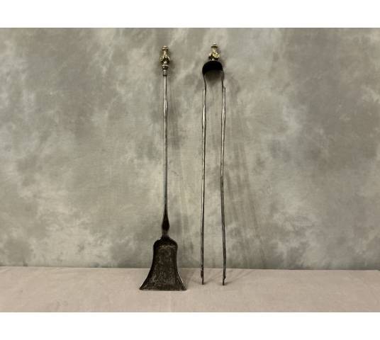 A 19th-century iron and bronze shovel and tongs set