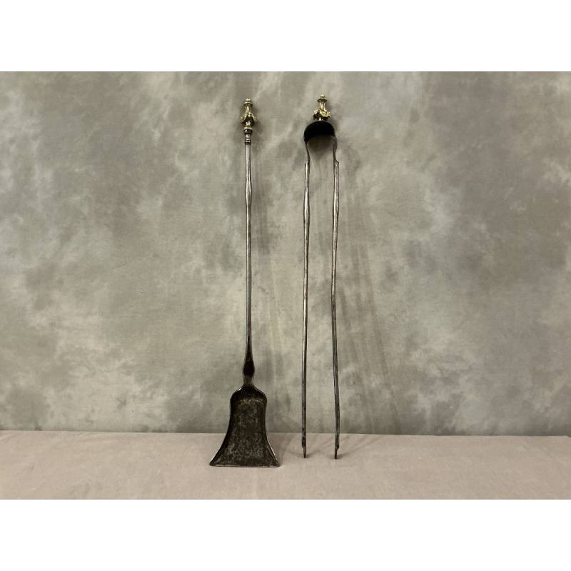 A 19th-century iron and bronze shovel and tongs set