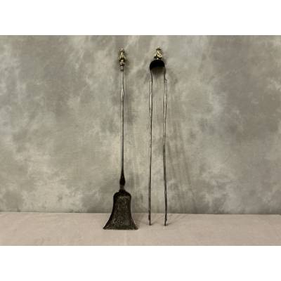 A 19th-century iron and bronze shovel and tongs set
