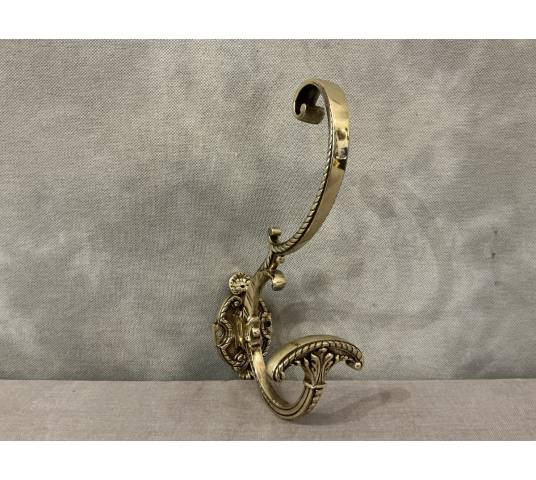 Polished and varnished bronze coat hook from the 19th century