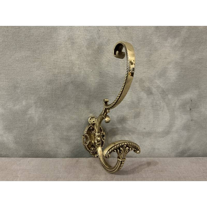 Polished and varnished bronze coat hook from the 19th century