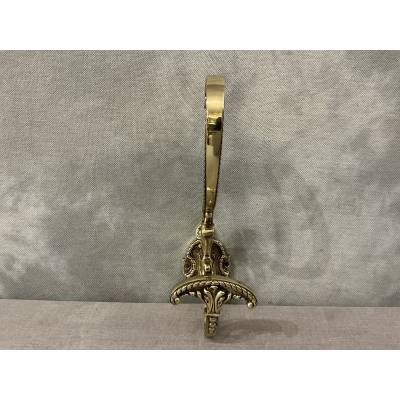 Polished and varnished bronze coat hook from the 19th century