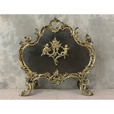 Polished and varnished bronze fireplace screen from the 19th century