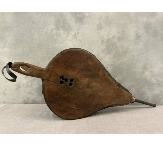 Antique rustic wooden fireplace bellows from the 18th century